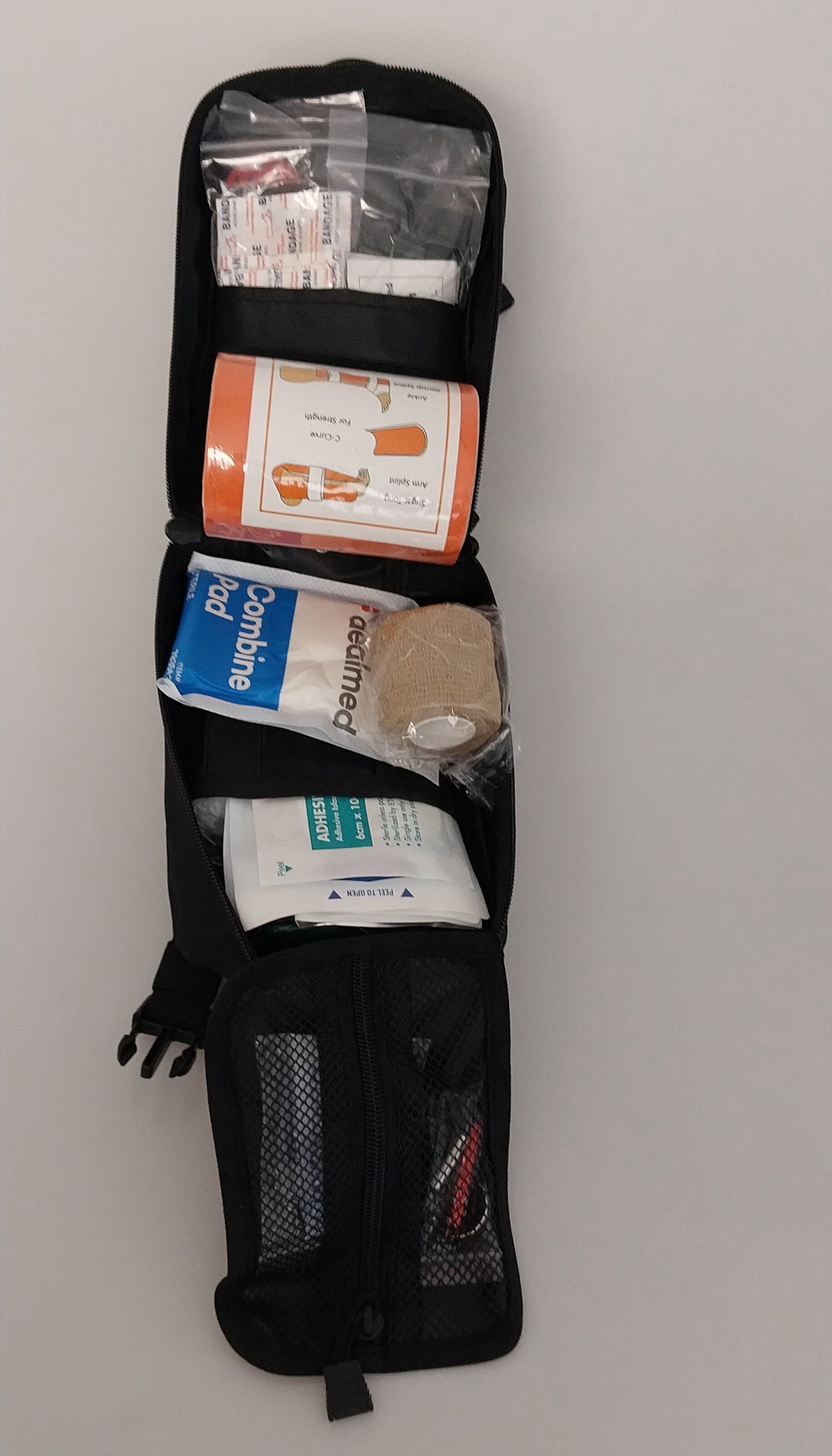 Black IFAK bag unzipped to show contents